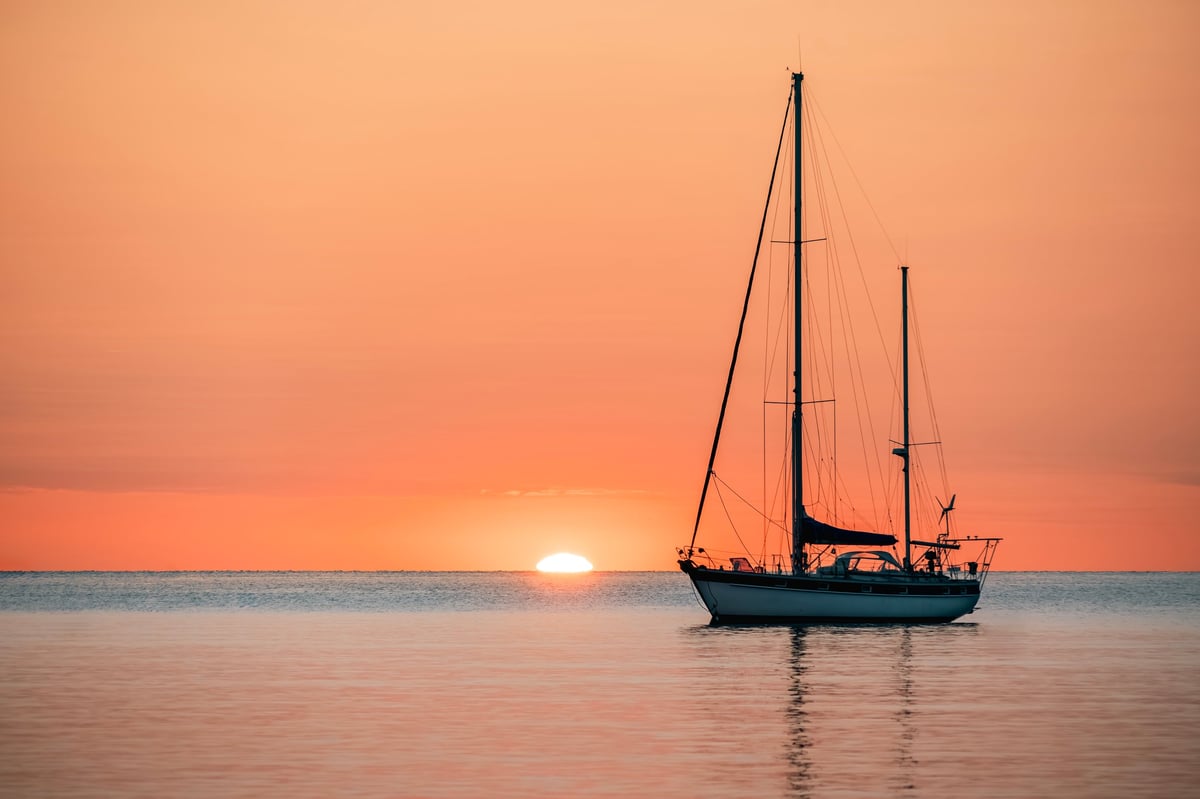 Small pleasure boat at sunrise in harbor