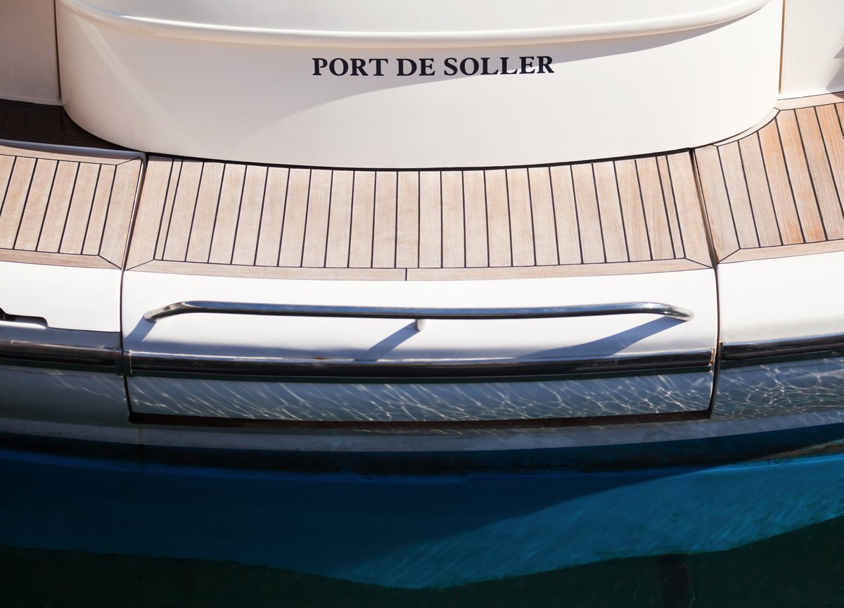 Stern of luxury boat with name at marina